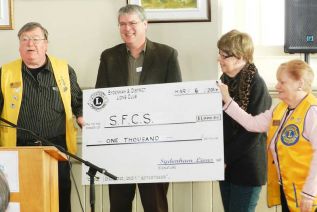 David Townsend receives a cheque for $1000 fron the Sydenham & Disttrict Lions
